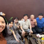 A cheerful group photo of satisfied customers and friendly staff at Rosie's Magical Spa in Vietnam.