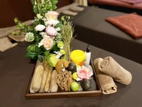 Rosie's Magical Spa Treatment Products - Rosie's Magical Spa A tray of massage and spa treatment products at Rosie's Magical Spa, including oils, herbs, and hot stones.