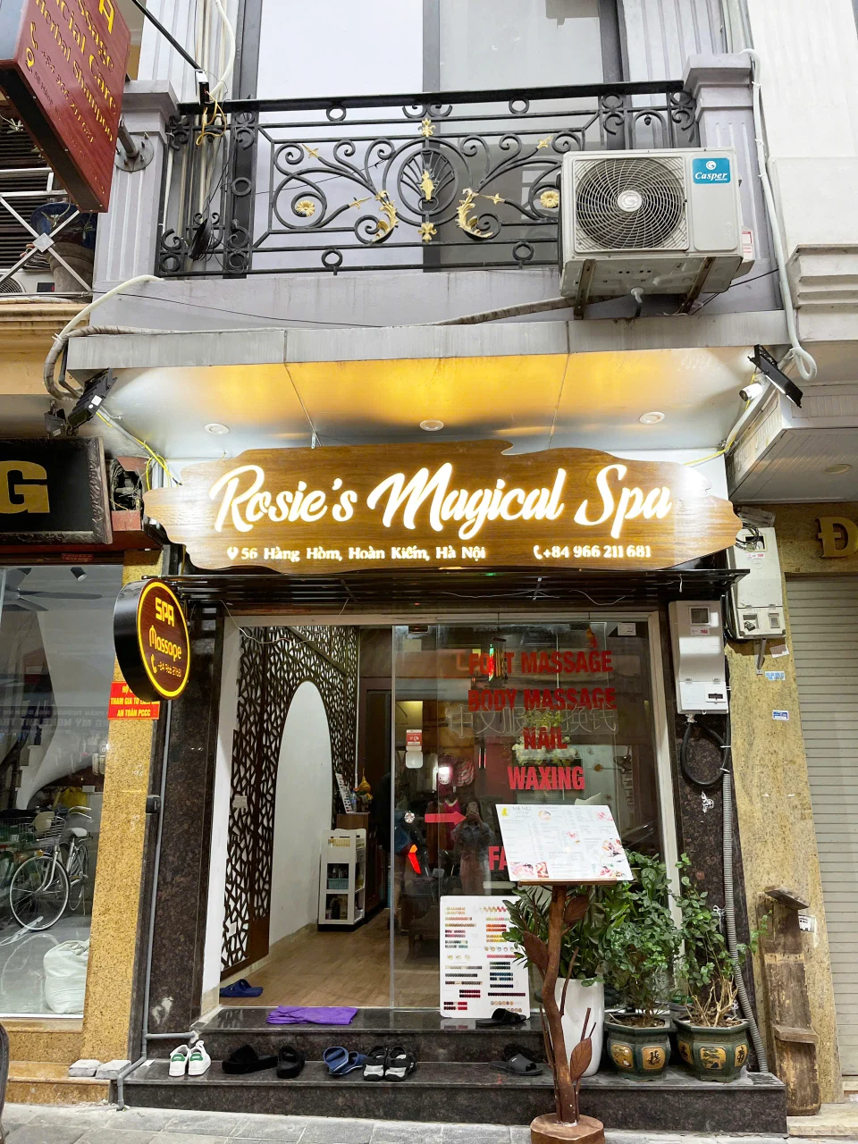 Exterior view of Rosie's Magical Spa at 56 Hang Hom, Hanoi Old Quarter, featuring a wooden signboard and glass entrance.